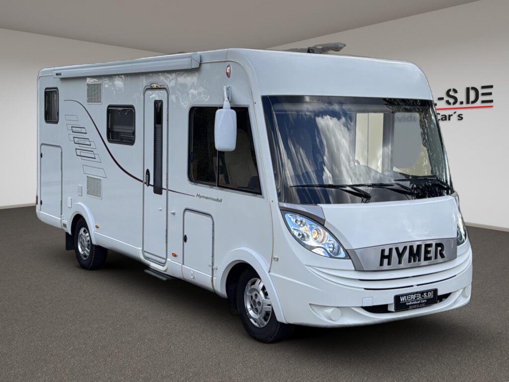 Weißes vollintegriertes Hymer Wohnmobil mit großer Frontscheibe, in Dreiviertelansicht.